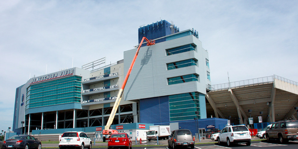 photo of a company power washing a stadium exterior