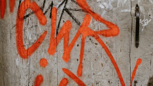 graffiti covering a weathered wall