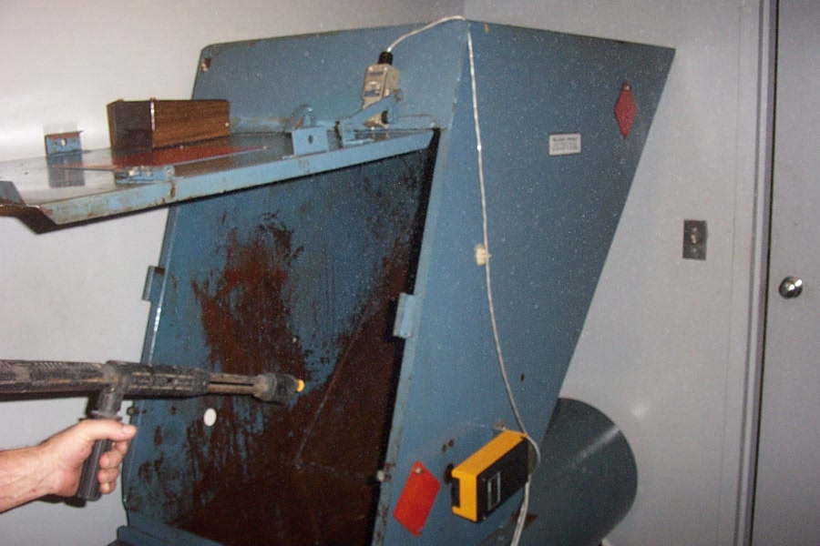 This is a picture of a compactor getting ready to be cleaned by OFF THE WALL