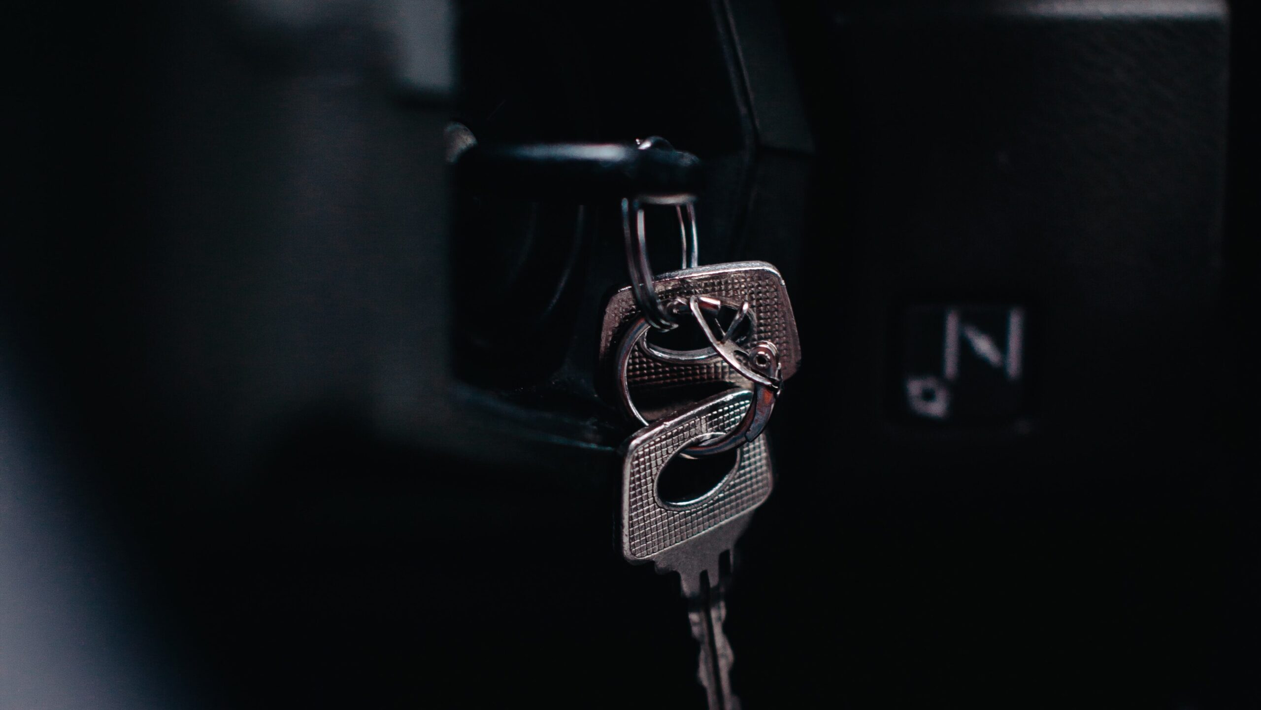 Photo of keys in the ignition of a parked car
