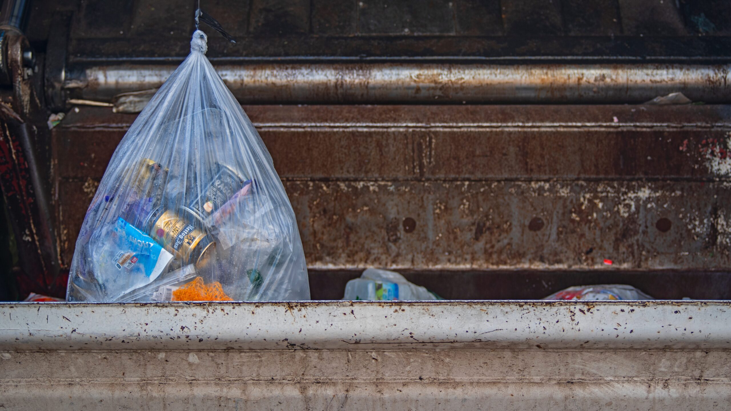 Image of dirty trash being loaded into a filthy trash chute