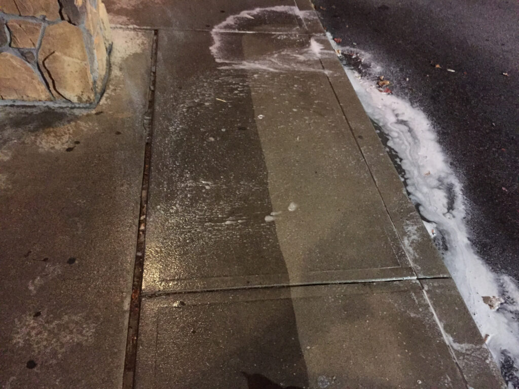 this is a dirty sidewalk that needs power washing. OFF THE WALL is here to help