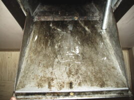 photograph of a dirty trash chute