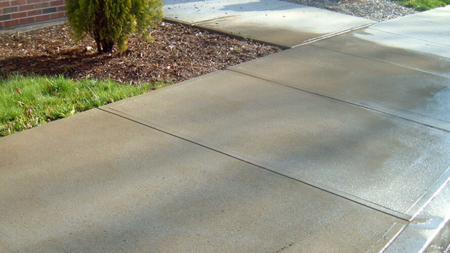 photo of a freshly-washed sidewalk shining in the sun