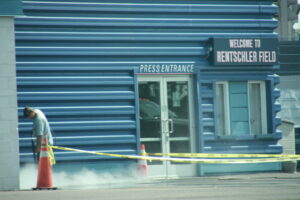 photo of a commercial power washing company employee cleaning a building exterior