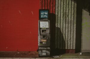 photo of an ATM covered in graffiti and grime