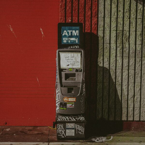 photo of an ATM covered in graffiti and grime
