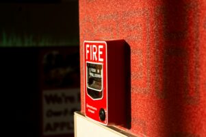 photo of a fire alarm near a trash chute