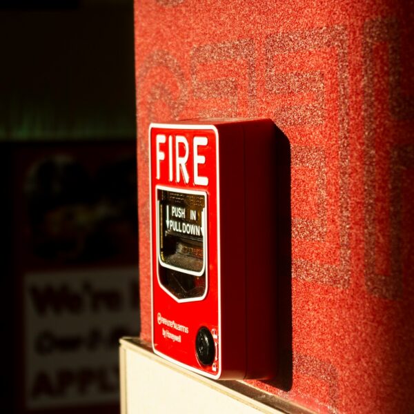 photo of a fire alarm near a trash chute
