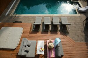 photo of an airbnb renter enjoying time on a clean and beautiful deck by the pool