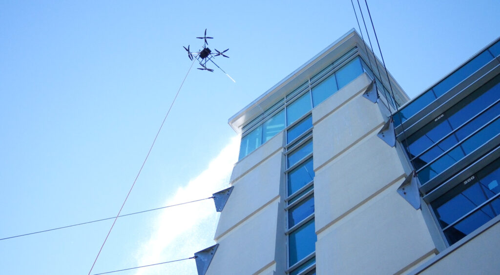 photo of the OFF THE WALL Power Washing drone cleaning the Goodwin University tower in East Hartford, CT