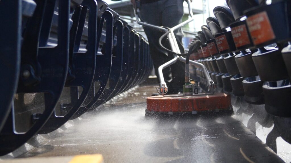 closeup photo of an OFF THE WALL team member cleaning the concrete at Dunkin Park in Hartford, CT