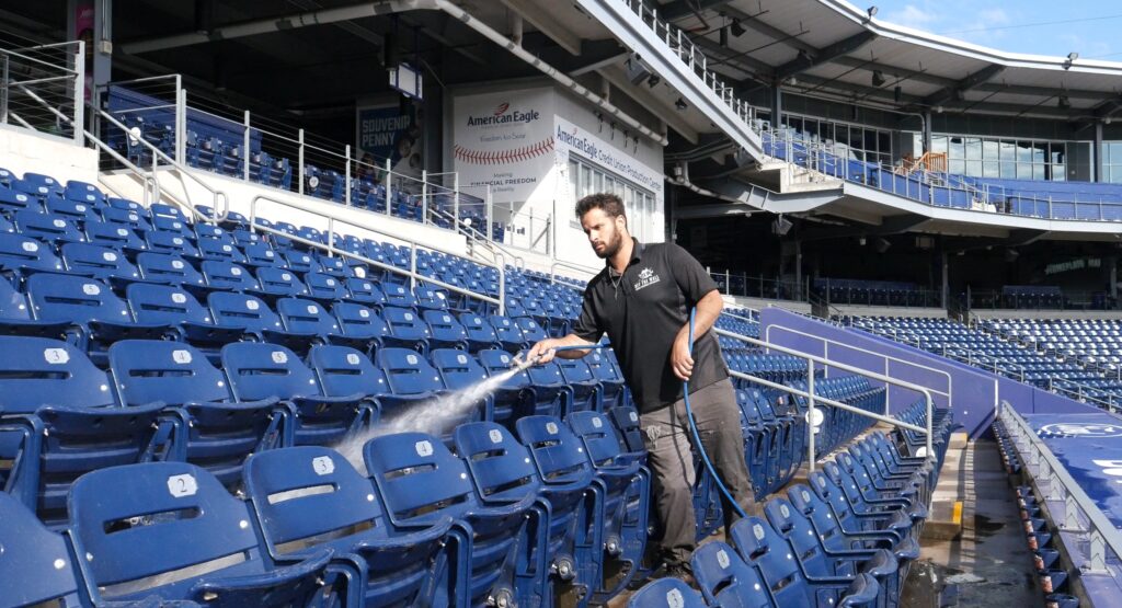 photo of an OFF THE WALL team member rinsing the seating at Dunkin Park in Hartford, CT
