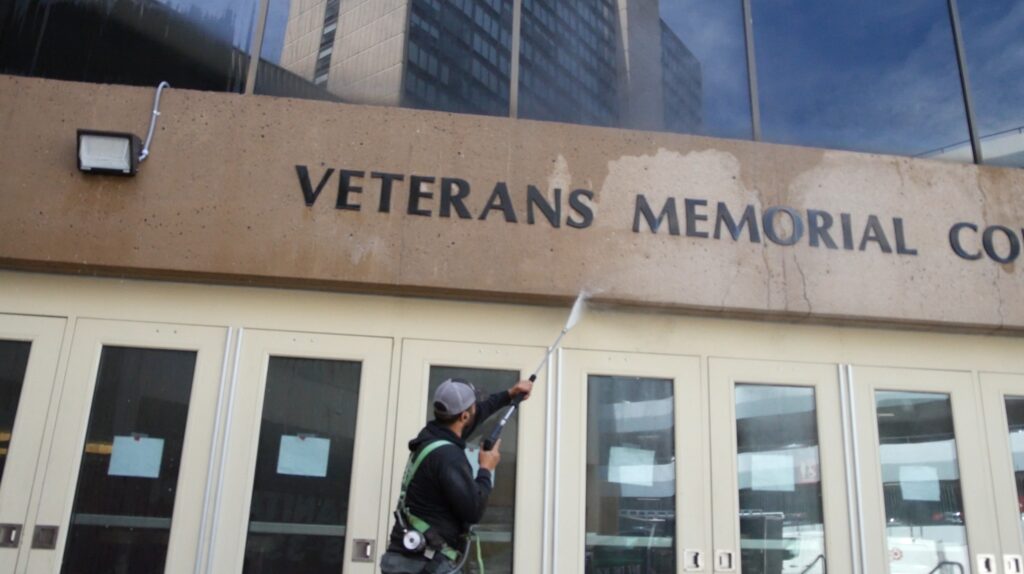 photo of an OFF THE WALL team member cleaning the entrance to PeoplesBank Arena in Hartford, CT