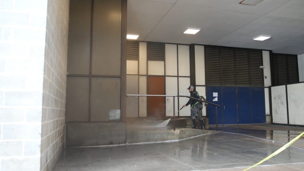 photo of an OFF THE WALL team member pressure washing the sidewalks outside PeoplesBank Arena in Hartford, CT