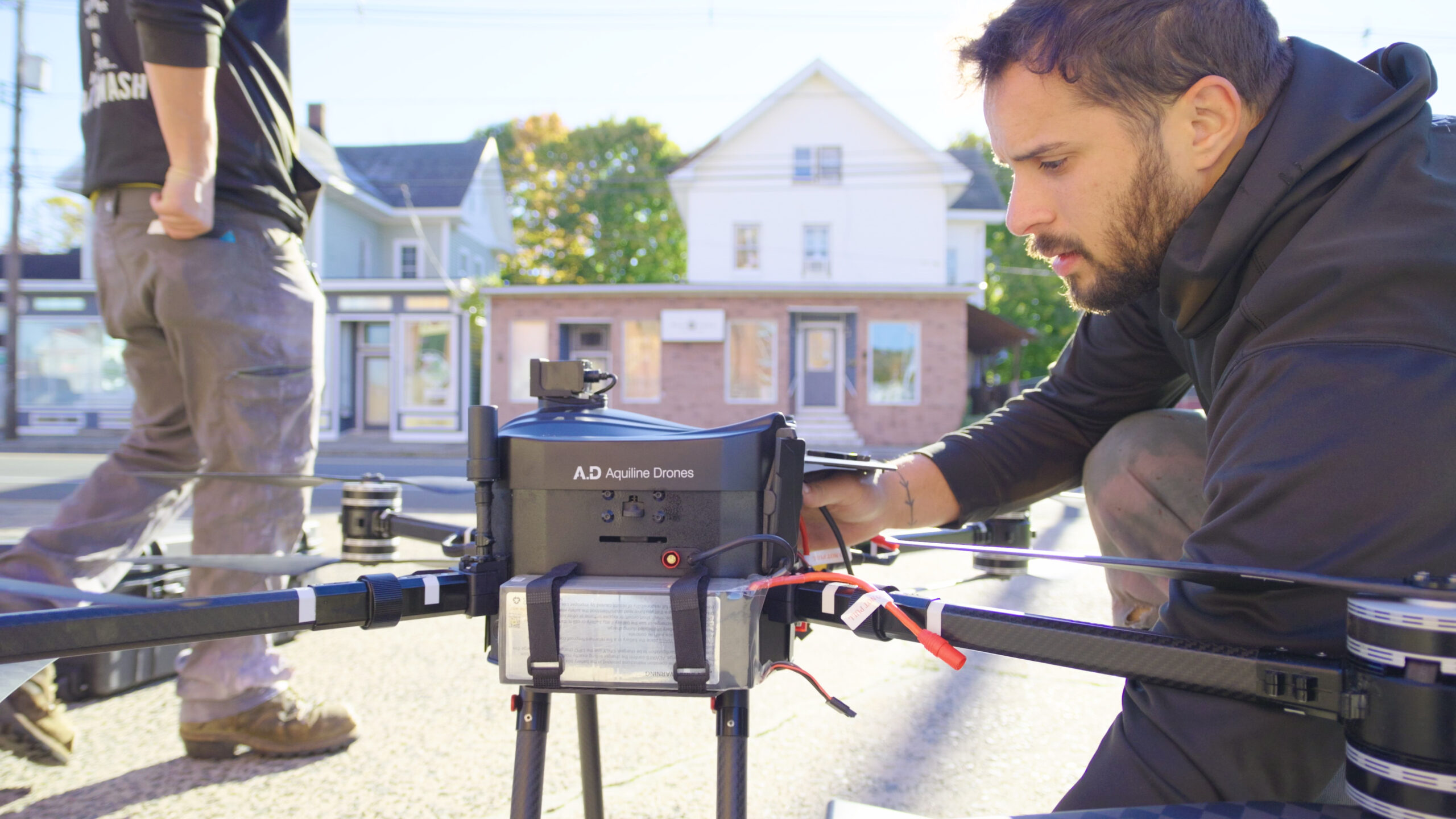 photo of the OFF THE WALL team setting up their cleaning drone to begin work cleaning a building in Wallingford, CT