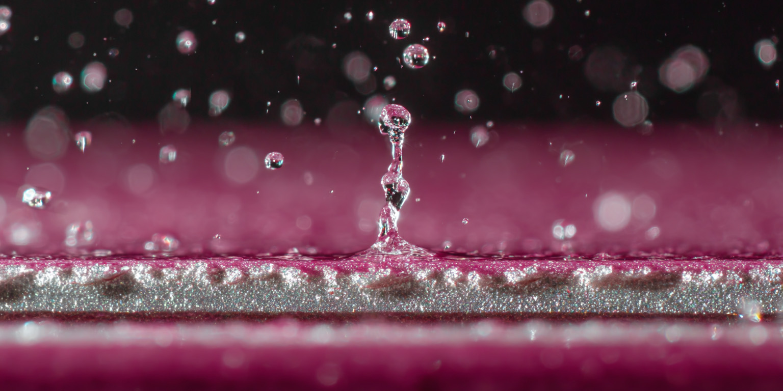 closeup image of water impact on a painted surface